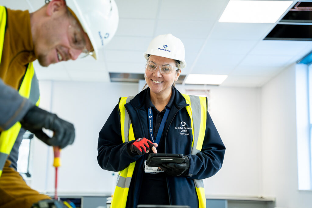 Two Dodd Group employees in PPE, at work